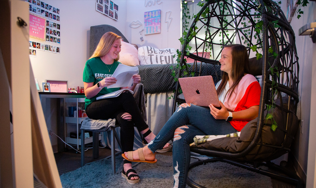 two female students studying in their dorm room