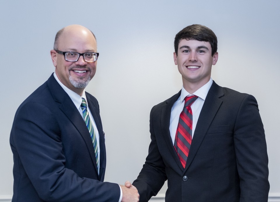Dr. Schecter shaking hands with Chase Kirkland