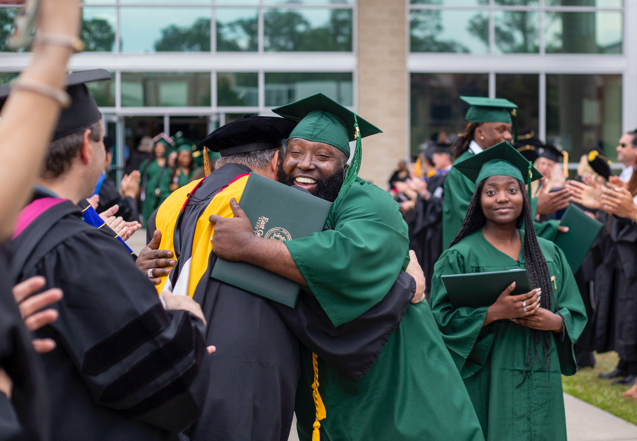 Graduate Graduate hugs professor